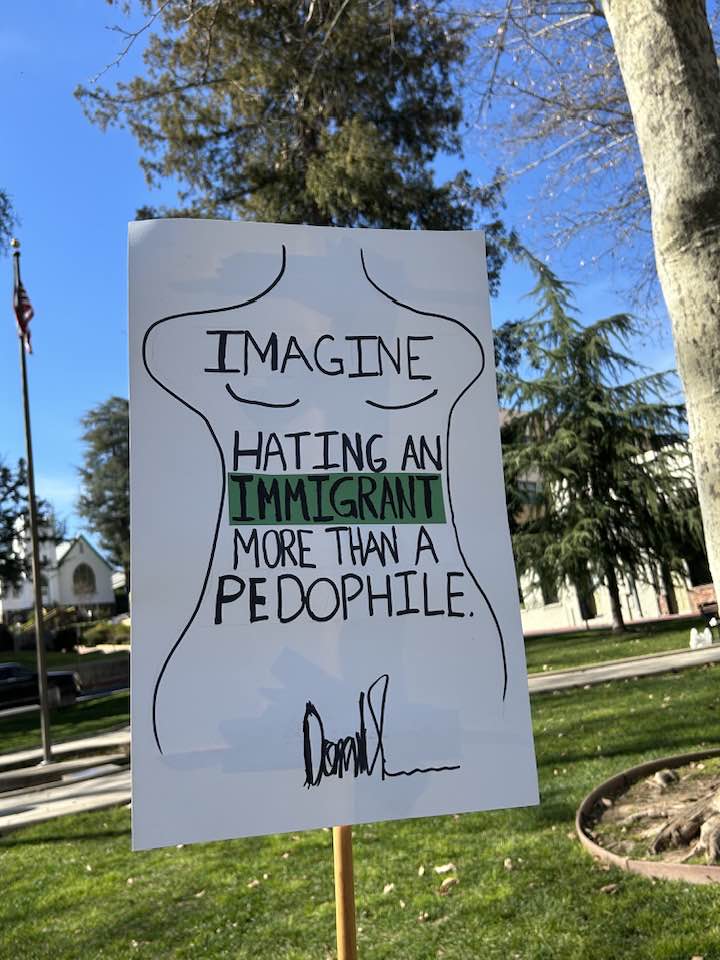 Photo by Laurie Sylwester. Sign depicting the drawing Donald Trump made in
      a birthday card for Jeffrey Epstein, which clearly shows that Trump was a
      very close friend of Epstein's